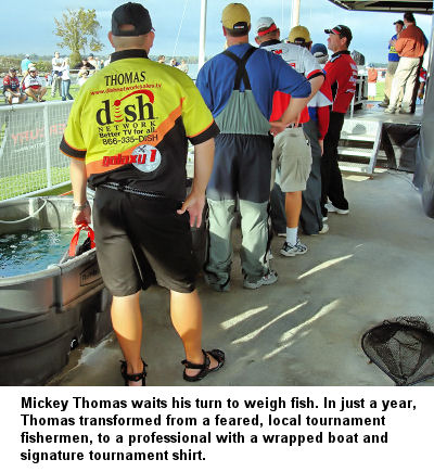 Mickey Thomas waits his turn to weigh fish. In just a year, Thomas transformed from a feared, local tournament fishermen, to a professional with a wrapped boat and signature tournament shirt.