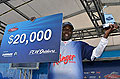 Co-angler champion Aymon Wilcox shows off his trophy and $20,000 check