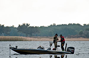 Elite Series pro Gerald Swindle and co-angler champion Marlon Crowder land a Lake Toho bass Elite Series pro Gerald Swindle and co-angler champion Marlon Crowder land a Lake Toho bass