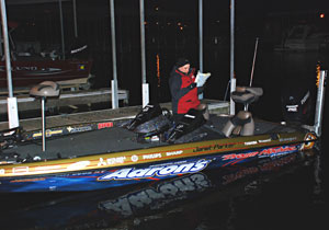 Bass pro Janet Parker studies a lake map before tournament morning take off Bass pro Janet Parker studies a lake map before tournament morning take off