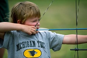 Photo of a young boy shooting a bow and arrow. Archery is one of the many DNR-sponsored activities families can enjoy during Detroit River Days. Photo of a young boy shooting a bow and arrow. Archery is one of the many DNR-sponsored activities families can enjoy during Detroit River Days.