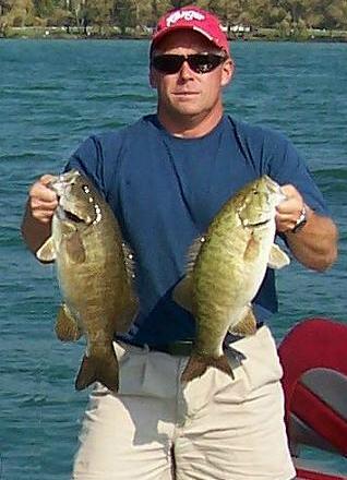 Derek with 2 big Mullett Lake smallmouth bass