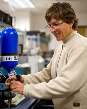NOAA's Patricia Lang prepares to measure methane levels inside a flask that is part of NOAA's global air sampling network. Network measurements, made from remote sites around the world, were critical in helping an international team of scientists understand the oxidizing or cleansing power of the global atmosphere and its sensitivity to natural and human-induced perturbations. Methane levels were a key point of comparison in the new study, published in Science. Photo Credit: NOAA