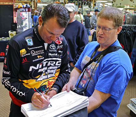 Michigan Bassmaster Elite Angler Kevin VanDam signs the Scientific Fish and Wildlife Conservation Act petition with GreatLakesBass.com owner Dan Kimmel. Photo Credit: Mark 'cameraguy' Gomez