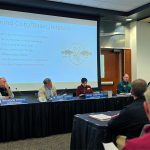 Dr. Lucas Nathan and Michigan Fisheries Chief Randy Claramunt present bass and goby science to the Michigan Natural Resources Commission on November 6, 2025.