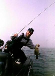 Jeff Bishop hoisting another St. Clair smallie into the boat.