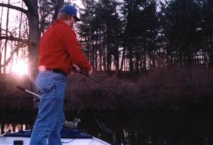 Angie took this shot of the sun setting behind the ridge over a Lansing Grand River backwater as I tried to pull one more bass off a laydown I’ve caught many from over the years.