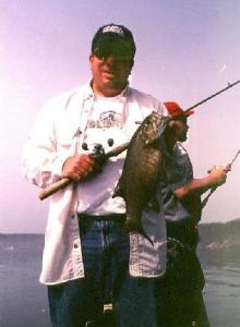 Mark with another nice smallie from our spring 03 Hardy Pond trip – with Brian Spear in the background.