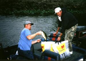 Lake Okeechobee EverStart of 2000, I’m bagging one of my Florida largemouths the first day. This bass came from inside one of the South Bay islands. 