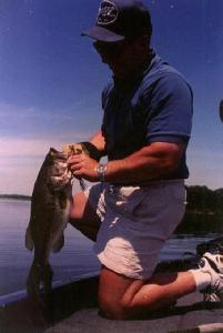 Here, Derek is unhooking a big L. Ovid largemouth.