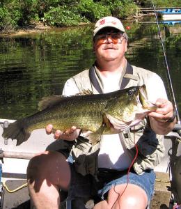 Angler Ed Schweifler with a huge 8 lbs 8 oz  largemouth from Michigan's Grand Traverse County. Released in 2005.