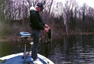 Larry dragged this fat 4+ largemouth out of the background brush - some of the best fun you can have on a lake.