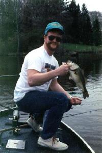 Angie took this shot of me with a fat prespawn Grand River bass I pulled from a snaggy steep outside bend with a Bomber 6A green crayfish crankbait. (Used in In-Fisherman magazine)