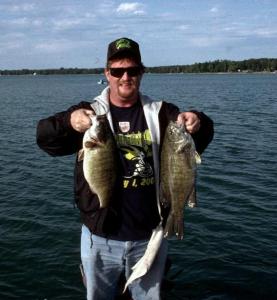 Two fat Northern Michigan smallies I caught during one or our annual fall trophy smallmouth bass hunts - these two from my favorite lake - Mullett. Not necessarily giants but well fed fatties, especially the chubby belly on the left!Photo by Larry Dekker