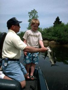 My Godson Aaron, with his daddy Derek & a nice Lake Ovid largemouth he caught on a Senko.