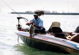 Ben Felton admires a quality Great Lakes smallie before releasing it for another day.