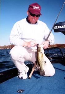 Regular fishing partner, Derek Baetz unhooking a largemouth from a jig and pig on Lake Lansing.